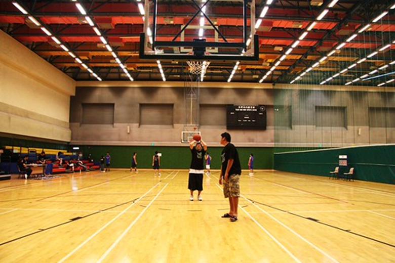 A coach and athlete practice free throws.