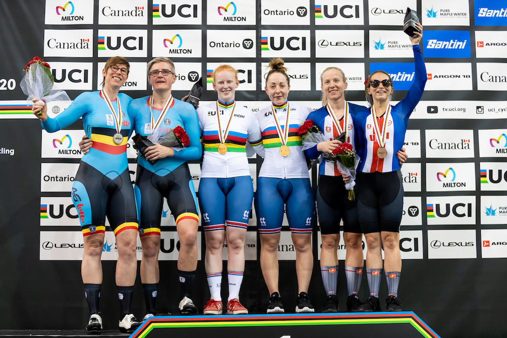 Stephanie Campbell and her pilot stand on the stage after receiving medals at the UCI World Championships.